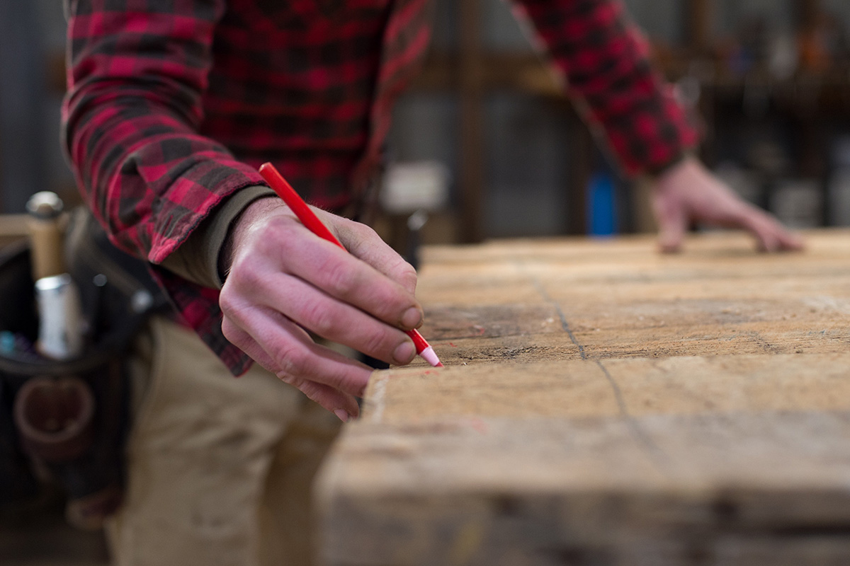 detail-of-mans-hands-marking-a-piece-of-wood_t20_jX8GlN